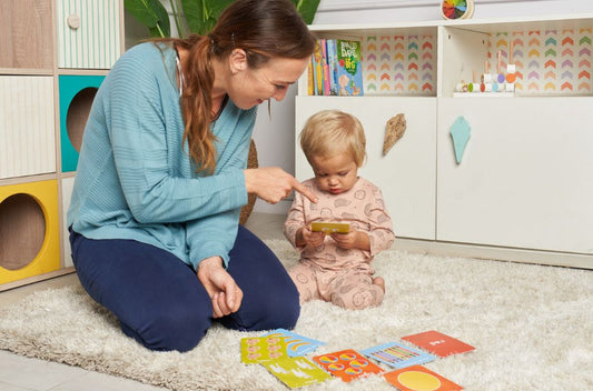article image showing -Woman and child playing with flash cards to boost learning and development