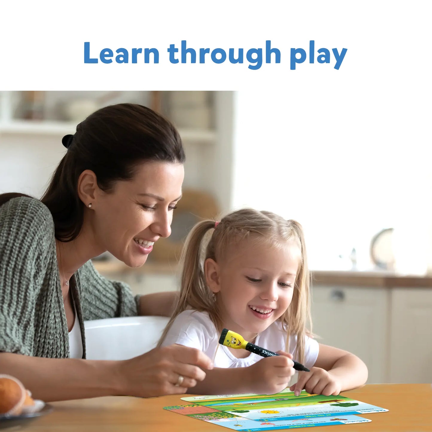 Smiling mother and daughter drawing on Skillmatics I Can Write Reusable Activity Mats