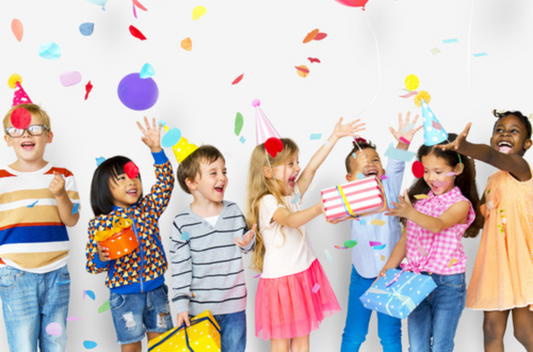 Kids enjoying a party and posing with confetti and gifts