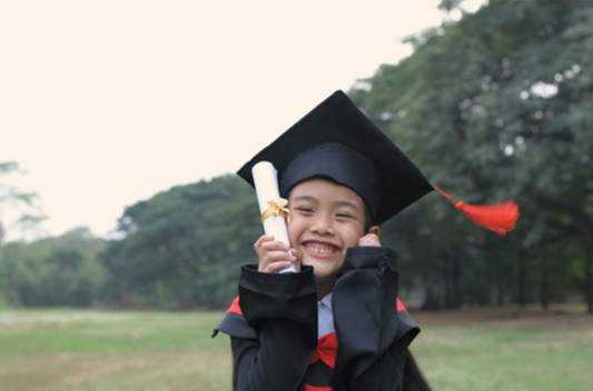 Kid happy at his preschool graduation