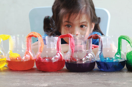 Girl child doing colorful science experiment