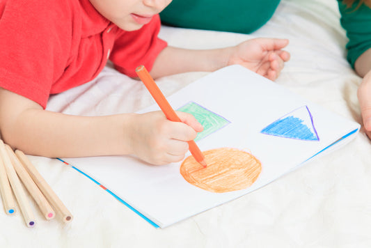 a boy coloring a circle