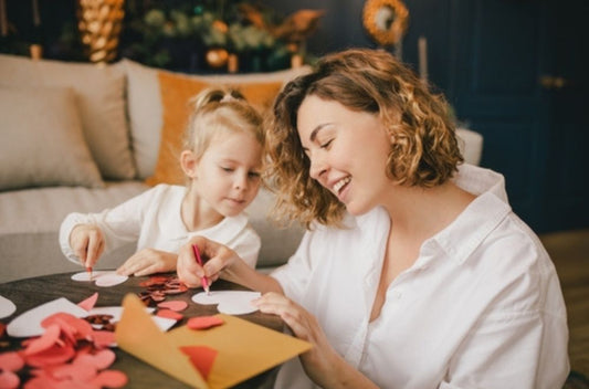 mom and daughter doing valentine's crafts 