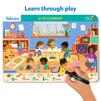 Skillmatics educational game board with children in a classroom scene and a hand holding a marker.