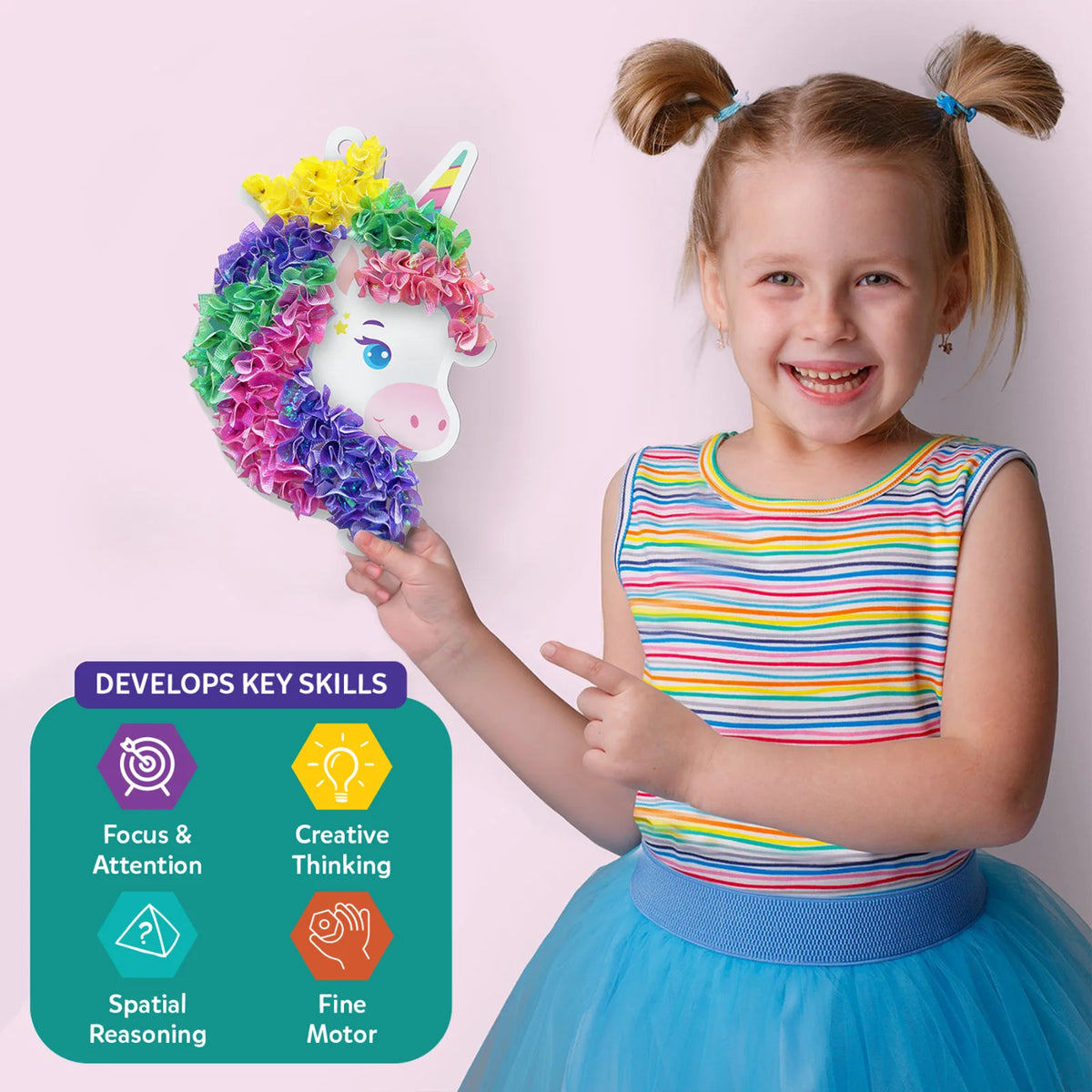 Smiling girl holding a colorful unicorn craft from Poke-in Art Magical Unicorn Dream Decor