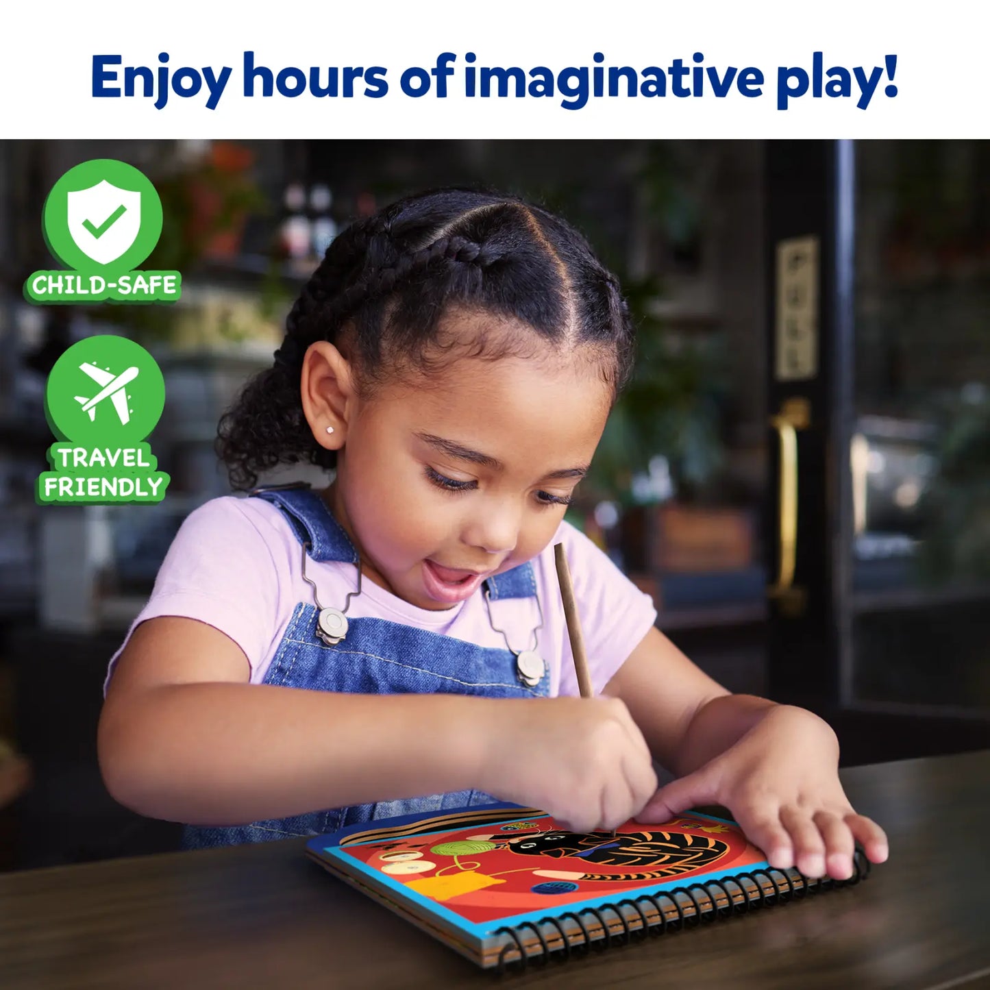 Child drawing in a colorful scratch art book from Magical Scratch Art Amazing Animals for ages 3-8