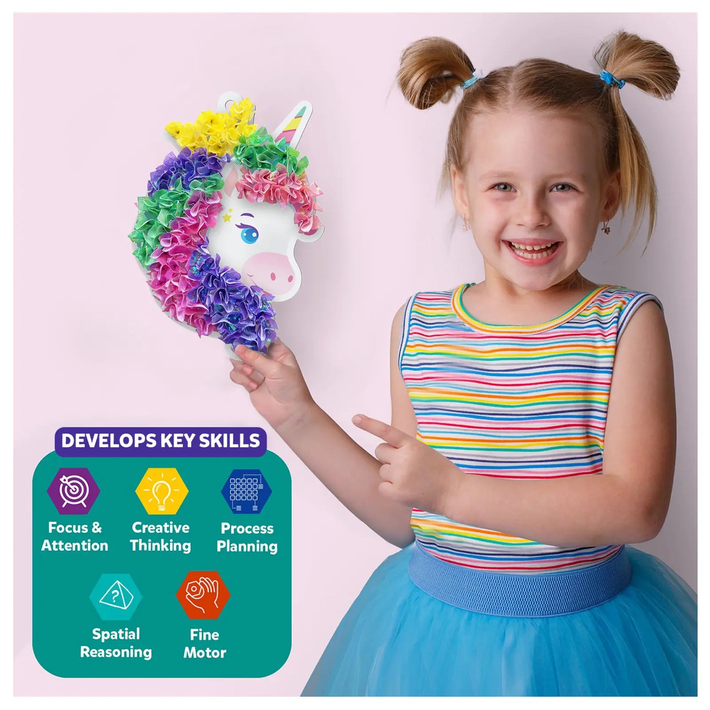 Smiling girl holding a colorful unicorn craft from Poke-in Art Magical Unicorn Dream Decor