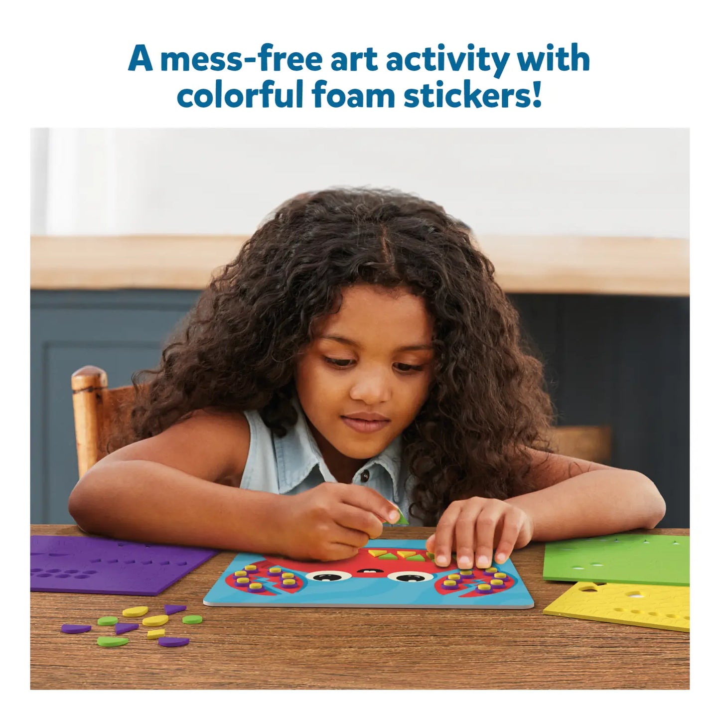 Child creating foam sticker ocean art activity from Fun with Foam Under the Ocean