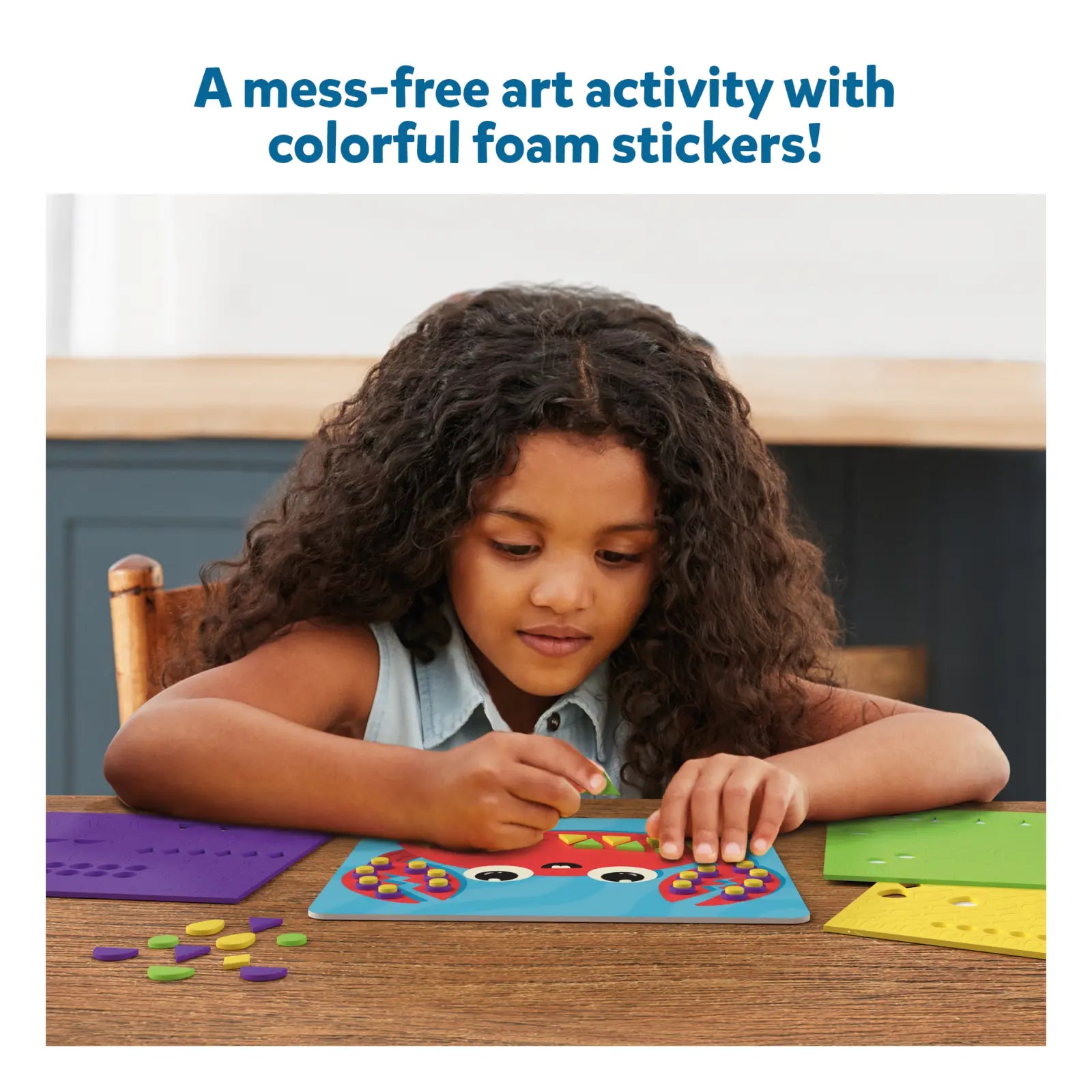 Child creating foam sticker ocean art activity from Fun with Foam Under the Ocean